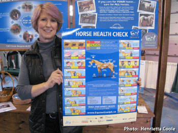 horse owner holding new Horse Health Check poster