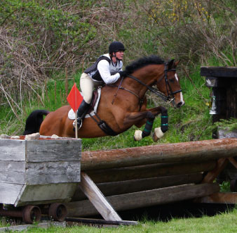 rider going over XC jump with body protector
