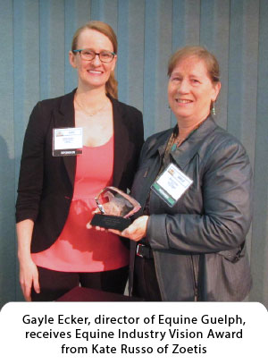 Gayle Ecker, director of Equine Guelph, receives Equine Industry Vision Award from Kate Russo of Zoetis